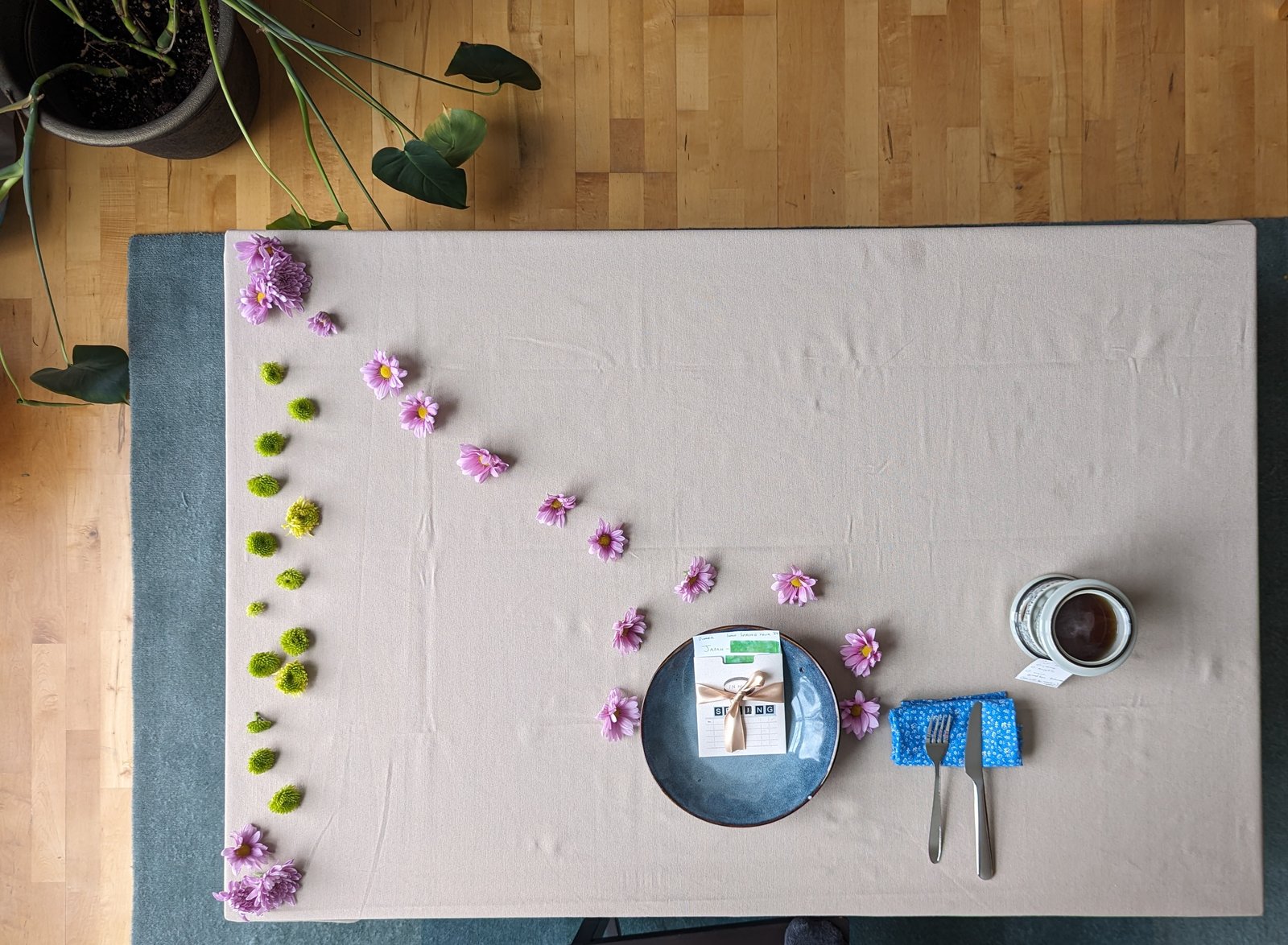 Around the World dinner, table set with flowers and a folded menu card.
