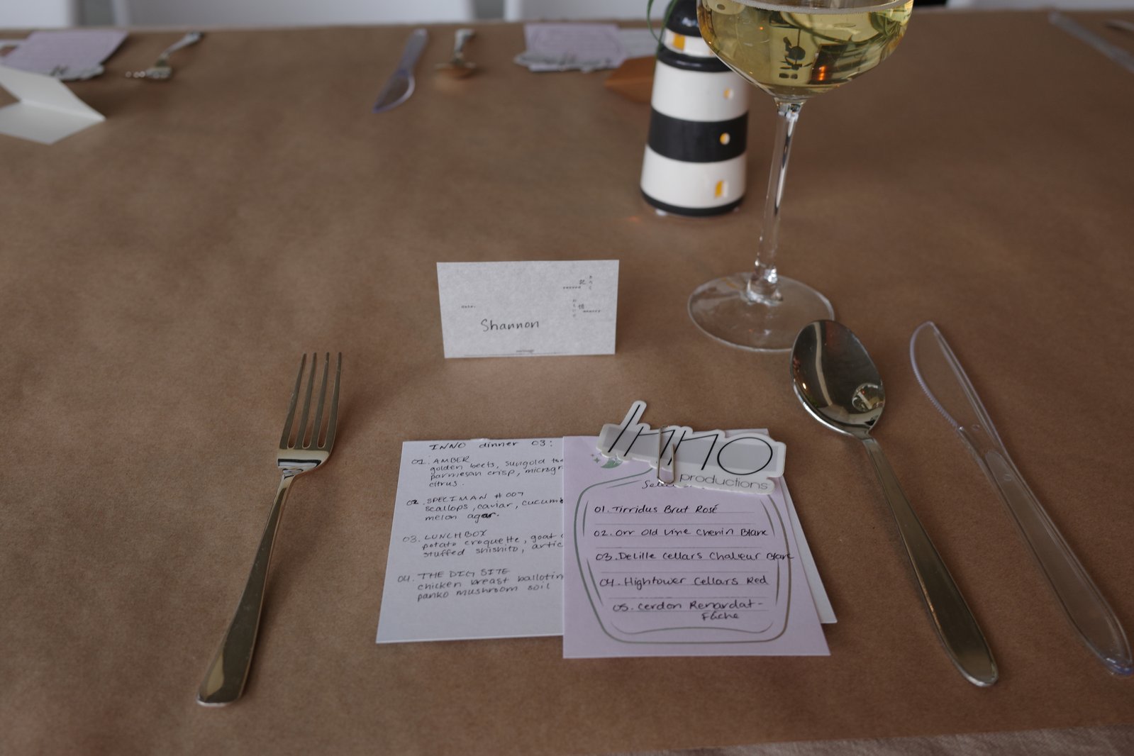 The menu card and wine list on the table, next to a place card reading Shannon.