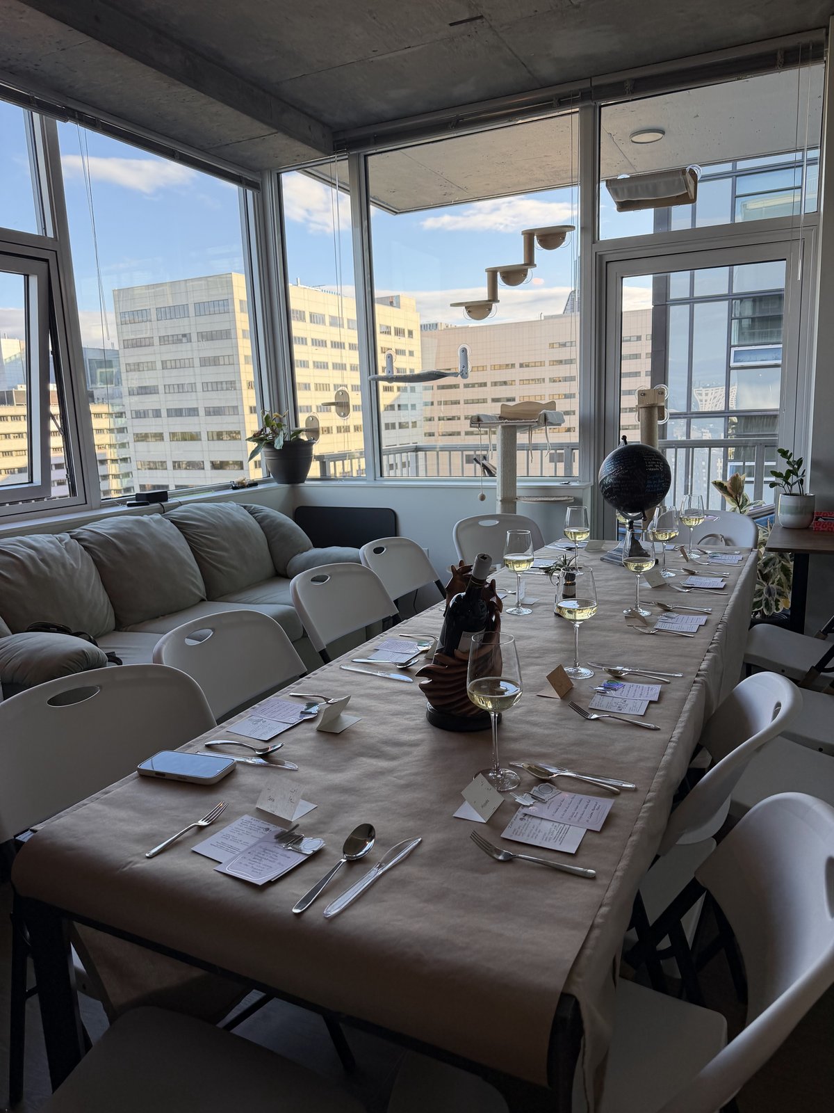 Museum / Fossils dinner, table set in front of a city skyline view.